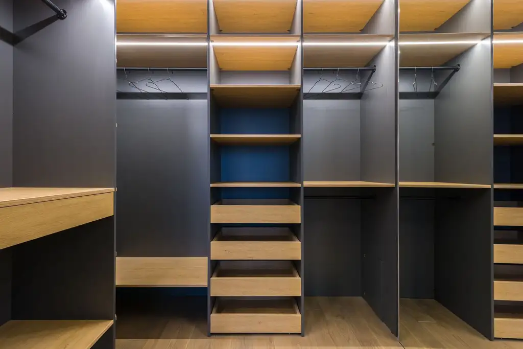 The inside of a fitted wardrobe: hanging, drawers and open shelving